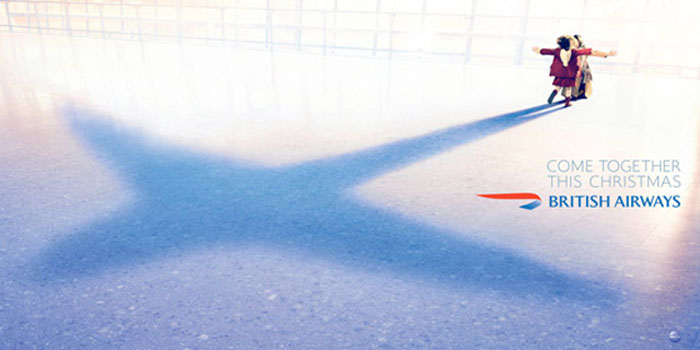 British Airways creative wanderlust Christmas advertisement.Emotional as two people embrace creating the shadow of an airplane
