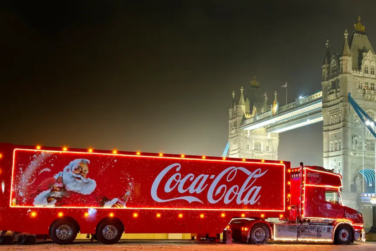 Coca-Cola's iconic red holiday truck with A picture of Santa on it