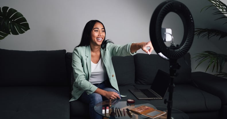 Instagram-young-woman-vlogging-online-with-smartphone-cam-an-2024-12-04-19-49-56-utc