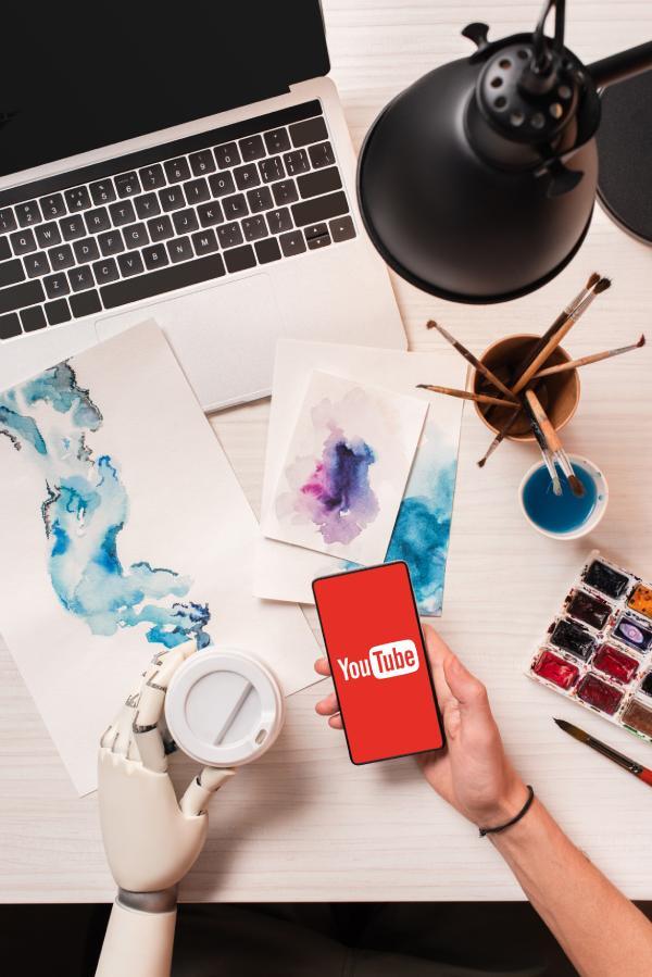 YouTUbe-cropped-view-of-designer-at-office-desk-with-robot-2024-11-19-19-35-11-utc