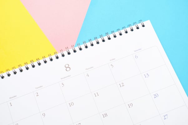 white-calendar-on-colorful-background-close-up-pl-2023-11-27-05-35-23-utc