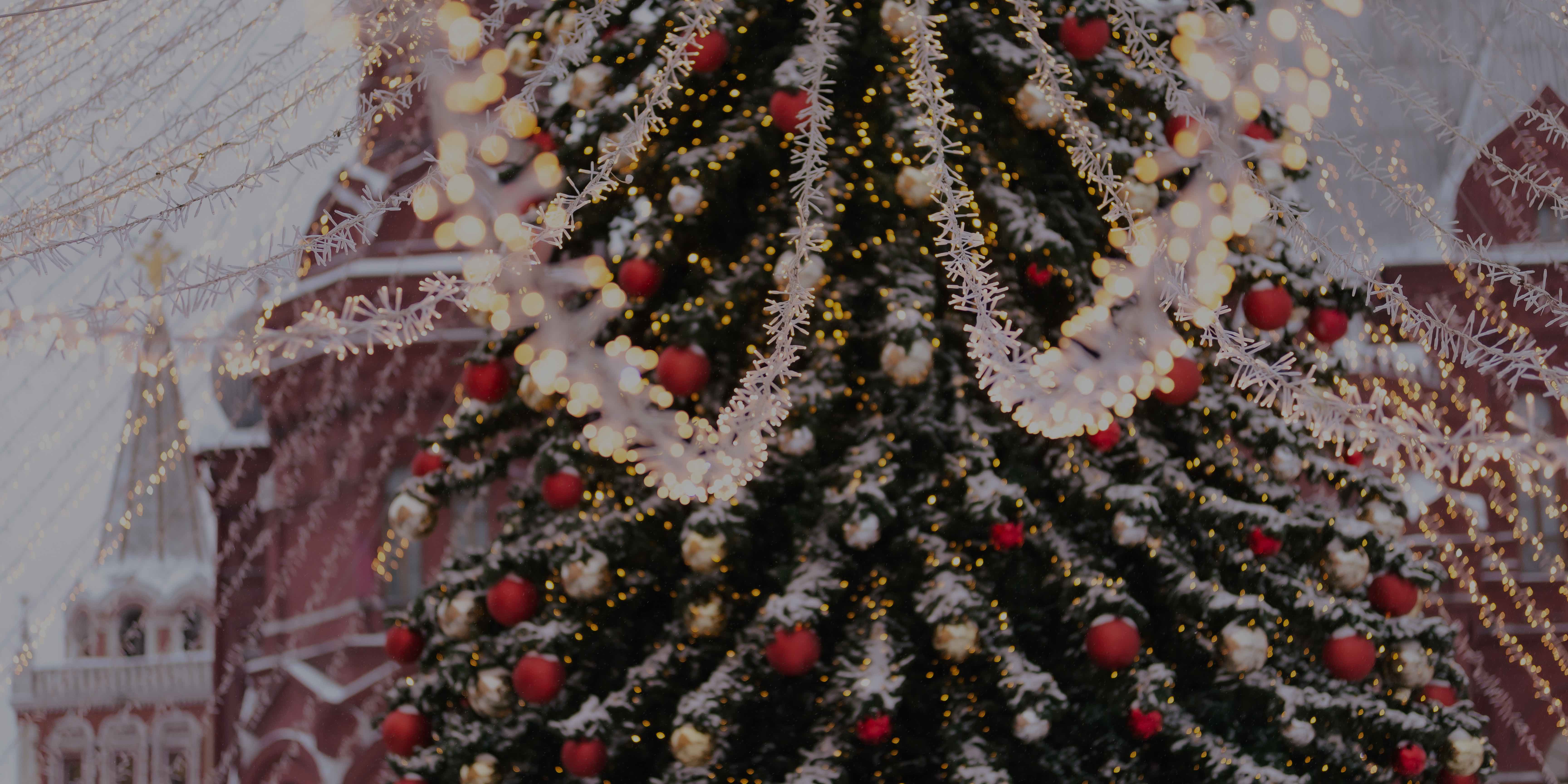 Christmas tree decorated with snow, ornaments, and tinsel